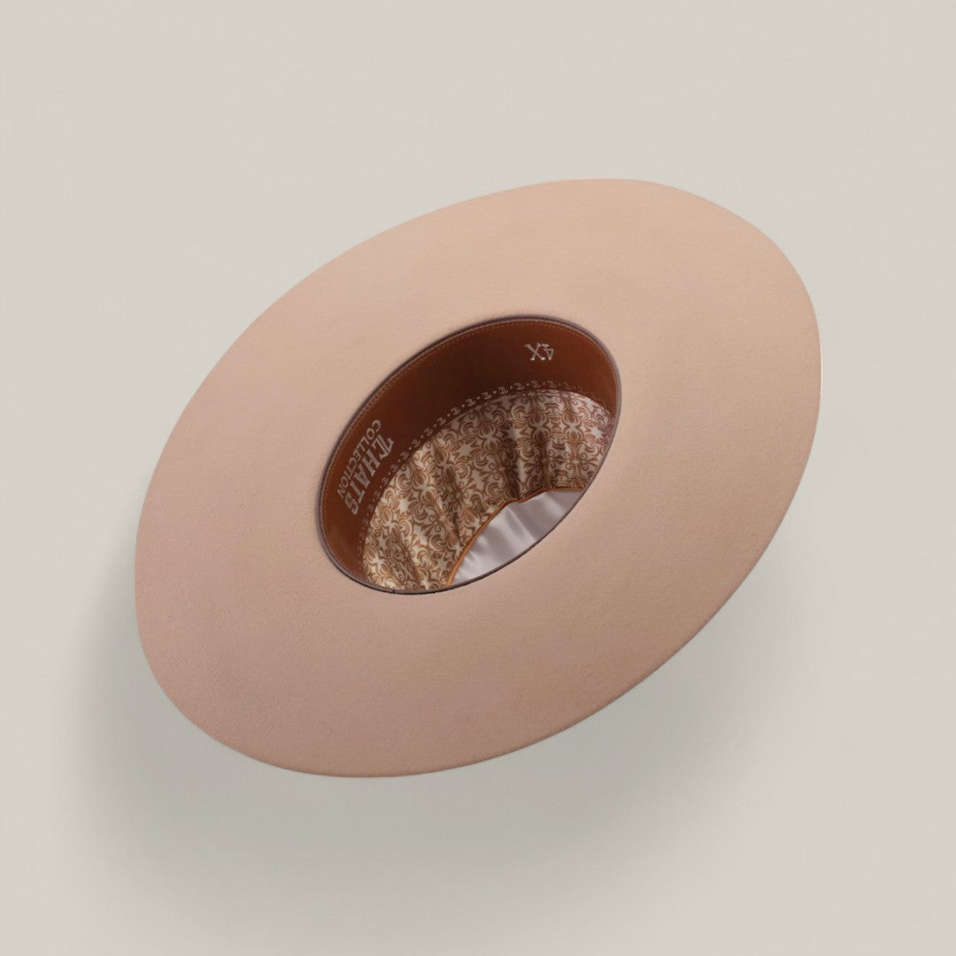 The 4X - Belly - TC Hats is displayed upside down, featuring a beige Western style with a shapeable crown, brown leather inner band, and patterned fabric lining, all set against a plain light background.