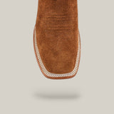 Top view of the Buck - Camel - Square Toe mens cowboy boot in brown suede, featuring detailed vamp stitching and a tan leather welt with white stitching, shown against a light beige background.