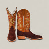 The Dusty - Classic Brown - Roper Toe boots feature brown suede feet, light brown leather shafts, and intricate yellow and red stitching, displayed against a plain beige background.