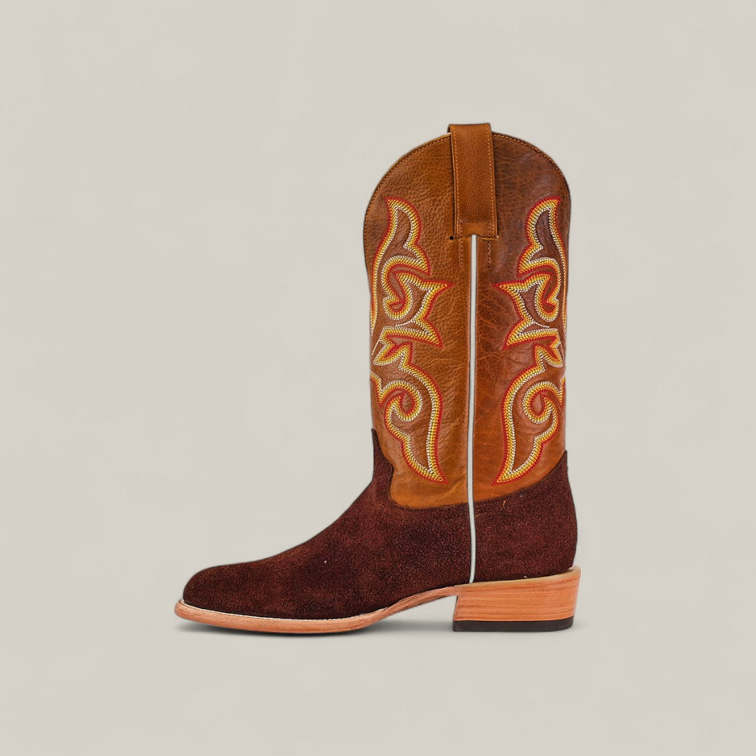 The Dusty - Classic Brown - Roper Toe boot features a light brown leather upper with orange and yellow stitching, a dark brown suede lower, and a tan wooden heel—perfect for fans of classic square-toe boots.