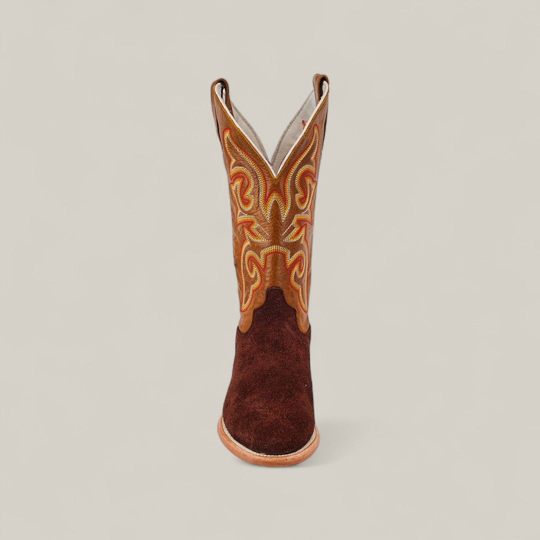A single Dusty - Classic Brown - Roper Toe boot featuring intricate yellow and orange shaft stitching is shown from the front against a plain light background.
