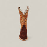 A single Dusty - Classic Brown - Roper Toe boot featuring intricate yellow and orange shaft stitching is shown from the front against a plain light background.
