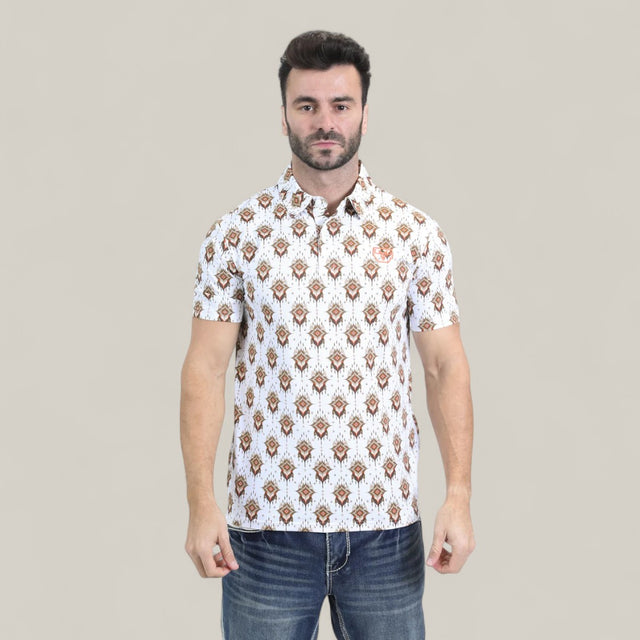 A man with short dark hair and a beard stands facing forward, wearing the Mens Performance Fabric Modern Fit Stretch Aztec Print White Polo (PGP10870) and blue jeans, against a plain light beige background.