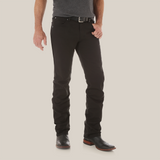 A person wears Mens Wrangler Retro Slim Fit Straight Leg Pants (88MWZBK) with a black belt and dark shoes. Their partly visible upper body features a dark gray shirt. The premium denim stands out against the white background.