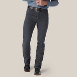 A person sports a blue denim shirt tucked into Wrangler Cowboy Cut Slim Fit jeans in charcoal gray, secured with a black belt. The ensemble is completed with black boots, and the photos focus spans from torso to feet against a plain background.