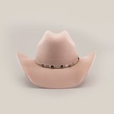 The 6X Chihuahua Belly, a beige cowboy hat made from premium sheep wool, showcases a wide brim and decorative band with metal accents around the crown, all set against a plain white background, embodying classic cowboy style.