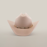 The 6X Country Belly, a Western classic cowboy hat in beige, is crafted from premium sheep wool and features a wide brim with a decorative band adorned with metal conchos, set against a plain white background.