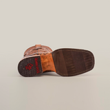 Close-up of the Handtooled Leave Orix cowboy boots sole shows detailed stitching and a slip-resistant rubber heel. The red Texas Country imprint appears with a textured grip pattern. Made from premium cowhide leather, this boot also boasts decorative stitching on the upper part.