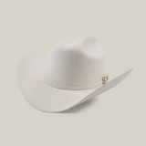 The 500X Superior White is a luxury Western cowboy hat with a wide brim and curved crown, made from top-quality belly beaver fur. It features a subtle band with a small gold emblem on a plain, light background.