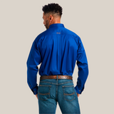 A man with short black hair wears a Solid Twill Classic Fit Shirt Blue (10006660) made of 100% cotton, paired with blue jeans and a brown belt. Facing away, he showcases the back of his classic outfit.
