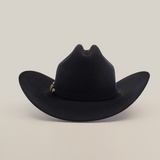 The 5X Dorado Black is a Western cowboy hat crafted from wild rabbit and beaver fur felt, featuring a wide brim and decorative band. Displayed against a plain white backdrop, it’s manufactured by Milano Hat Co. and exudes classic charm.